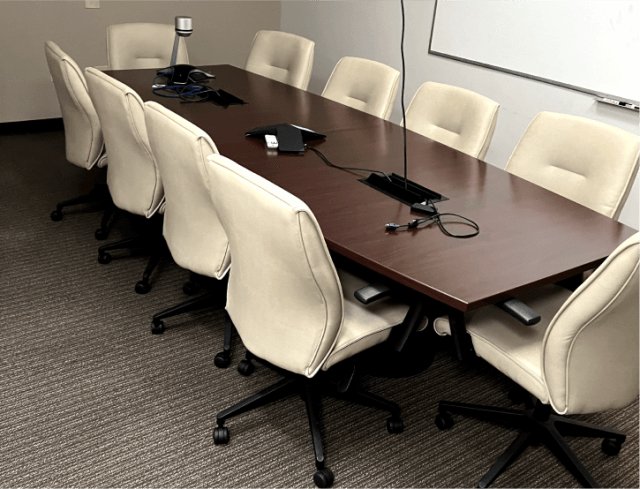 An office meeting room with conference table and chairs